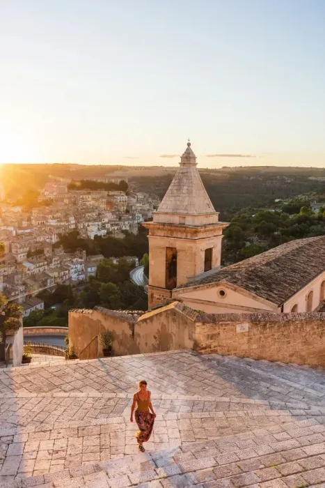Framed Print : Ragusa Ibla, Sicily. A woman walking on the stairs with Ragusa old town in the background Framed Print : Ragusa Ibla, Sicily. A woman walking on the stairs with Ragusa old town in the background