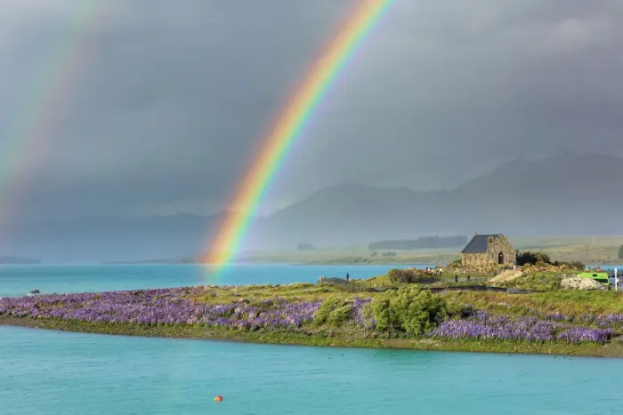 Framed Print : A rainbow over the church of the Good Shepherd and the lupins in bloom by the lake on a