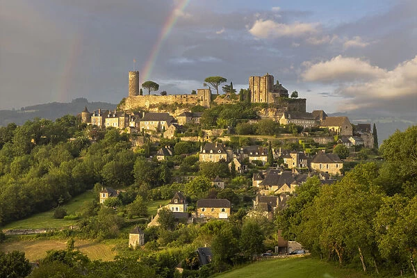 A rainbow and the hilltop village of Turenne, Turenne, Correze, Nouvelle-Aquitaine