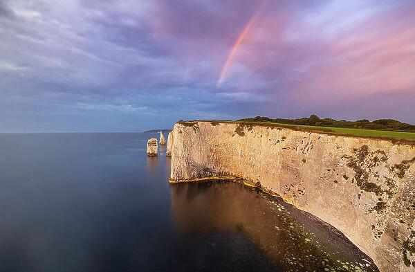 Rainbow at Sunrise at Old Harry Rocks during summer, Handfast Point, Purbeck isle, Dorset, England, United Kingdom