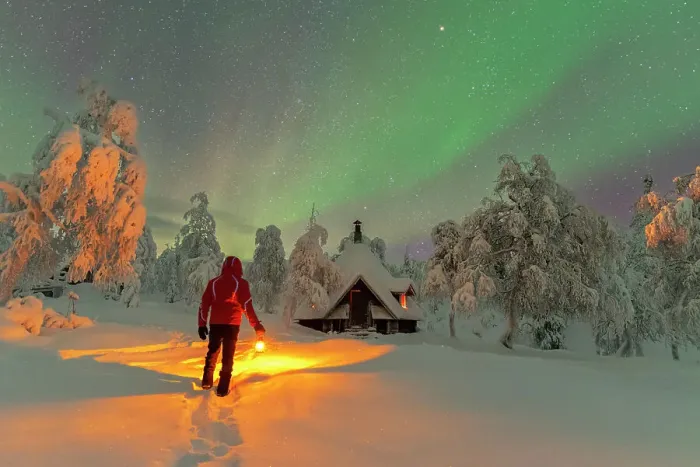 Framed Print : Rear a man with lantern admiring northern lights (aurora borealis) from a finnish hut (kota) in the icy forest, Lapland, Finland (MR) Framed Print : Rear a man with lantern admiring northern lights (aurora borealis) from a finnish hut (kota) in the icy forest, Lapland, Finland (MR)