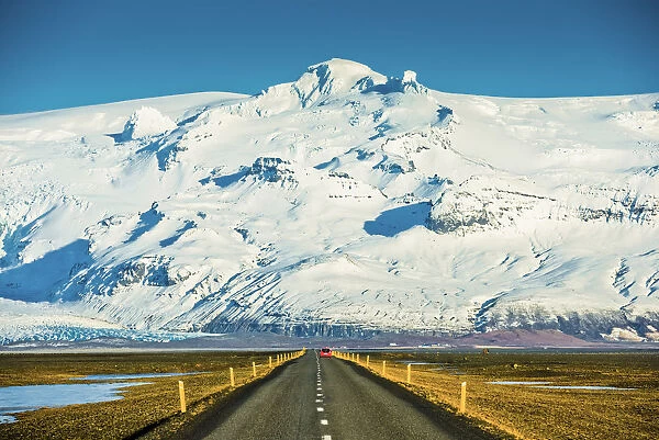 Red Car on Road leading to Vatnajokull Glacier, Iceland