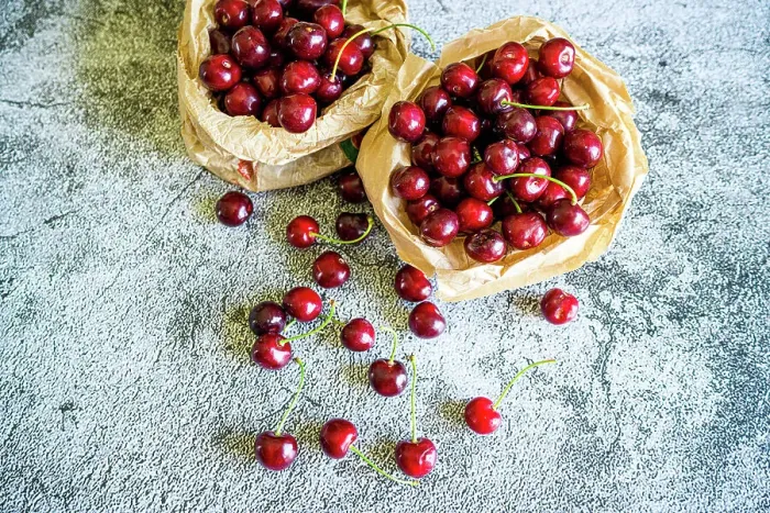 Framed Print : Red cherries ready to eat on a table, high angle view Framed Print : Red cherries ready to eat on a table, high angle view