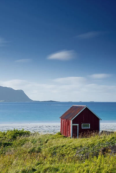 Red Fishing Hut on Ramberg Beach, Lofoten Islands, Norway