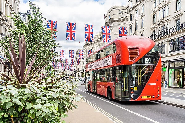 A red London bus and Union flags on Regent street, London, England, UK