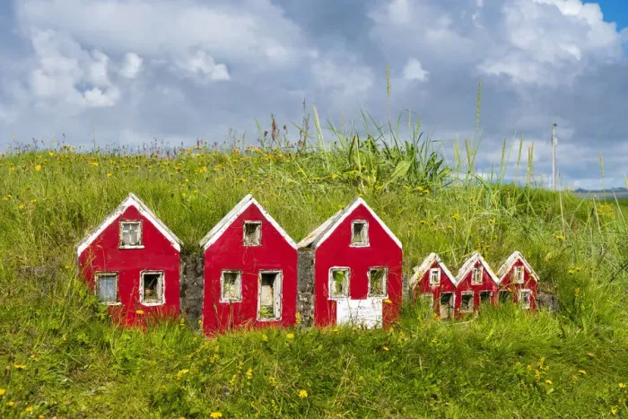 Framed Print : Red miniature Icelandic houses on green grass near Strandakirkja church, Selvogur, Reykjanes Peninsula, Iceland
