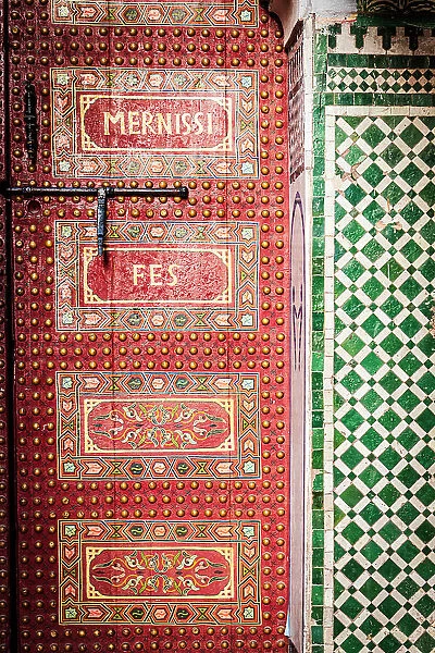 Red painted old wooden doorway, Fez, Morocco