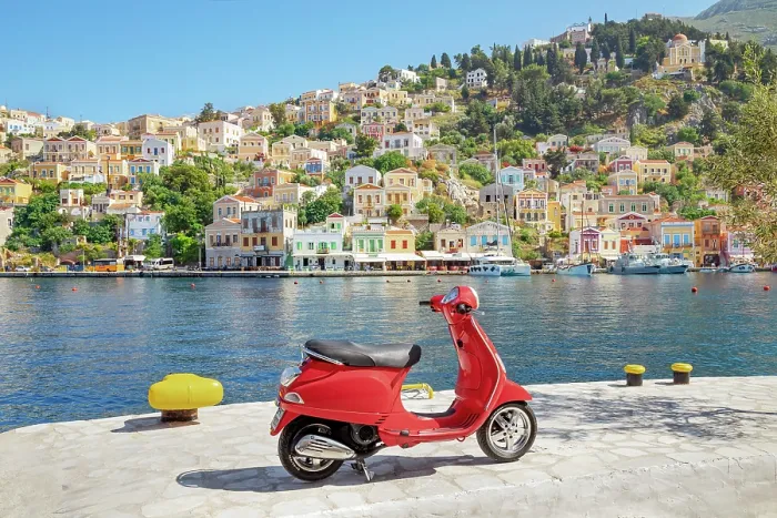 Framed Print : Red vespa scooter parked at Gialos harbour, Gialos, Symi Island, Dodecanese Islands, Greece
