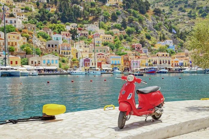 Framed Print : Red vespa scooter parked at Gialos harbour, Gialos, Symi Island, Dodecanese Islands, Greece