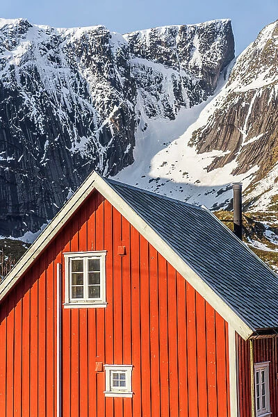 Red wood facade of traditional Rorbu house in the snow, Reine, Nordland county, Lofoten Islands, Norway