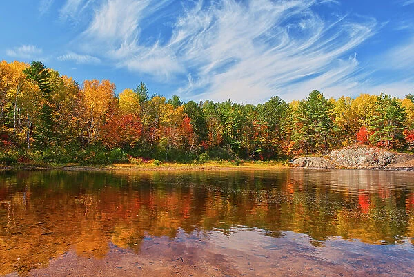 Reflection on the Aux Sables River in autumn Chutes Provincial Park, Ontario, Canada