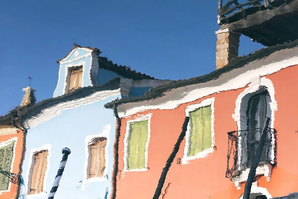 Reflection of colourful buildings in a canal on Burano Island, Burano, Venice, Italy
