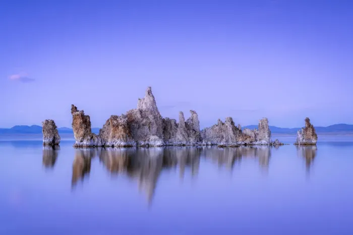Framed Print : Reflection of rock formation in South Tufa on Mono Lake against blue sky at dusk Framed Print : Reflection of rock formation in South Tufa on Mono Lake against blue sky at dusk