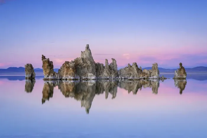 Framed Print : Reflection of rock formation in South Tufa on Mono Lake against blue sky at sunset