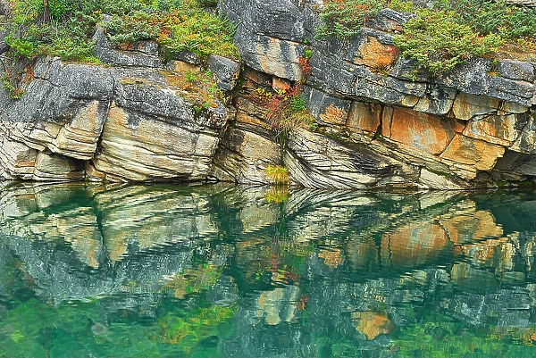 Reflection of shoreline rocks in Horseshoe Lake, Jasper National Park, Alberta, Canada