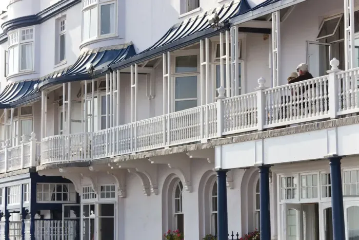 Framed Print : Retired couple sat on balcony, Regency houses, Sidmouth, Devon, UK Framed Print : Retired couple sat on balcony, Regency houses, Sidmouth, Devon, UK