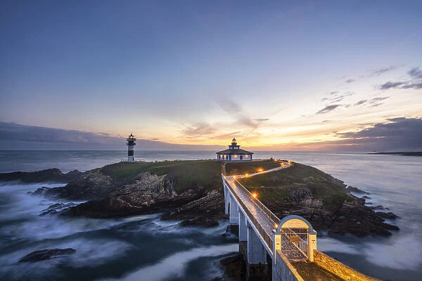 Ribadeo, Province of Lugo, Galicia, Spain. Illa Pancha lighthouse at dusk