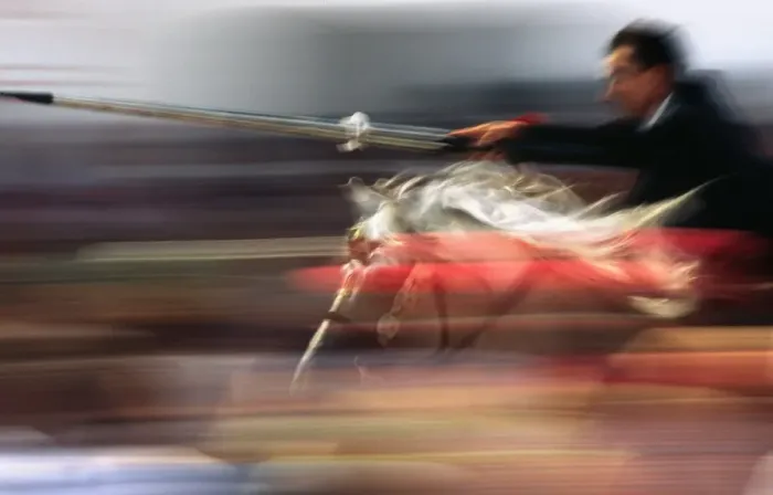 Framed Print : A rider on horseback speeds through the crowd attempting Framed Print : A rider on horseback speeds through the crowd attempting