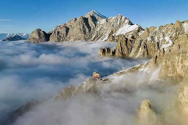 Rifugio rosalba emerge from the clouds. Grignetta, Grigne group, Lake Como, Italy