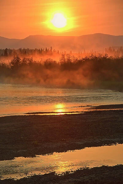 Rising fog on the Deasadeash River at sunrise and the Kluane Ranges, the easternmost of the St Elias Mountains. Kluane National Park, Yukon, Canada