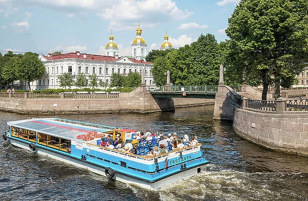 A river cruise passing by Saint Nicholas Naval Cathedral (Nikolskiy Morskoy Sobor) and Krasnogvardeysky Bridge (Red Guard Bridge), Saint Petersburg, Russia