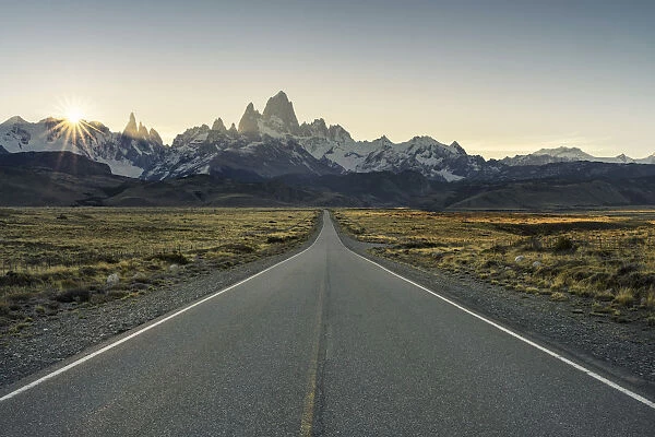 Road leading to El Chalten, with Fitz Roy range in the background at sunset