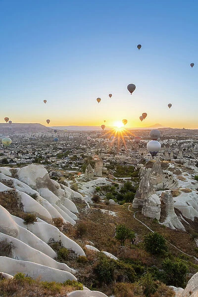 Rock formations, hot air balloons at sunrise, Goreme, Goreme Historical National Park, Nevsehir District, Nevsehir Province, UNESCO, Cappadocia, Central Anatolia Region, Turkey