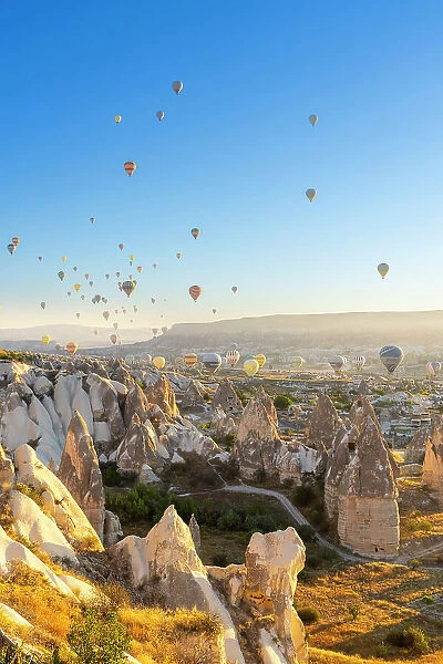 Rock formations, hot air balloons at sunrise, Goreme, Goreme Historical National Park, Nevsehir District, Nevsehir Province, UNESCO, Cappadocia, Central Anatolia Region, Turkey