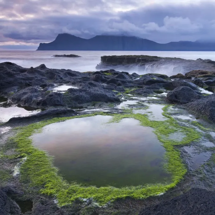 Framed Print : Rockpools on the shores of Gjogv on Eysturoy, looking towards the mountainous island Framed Print : Rockpools on the shores of Gjogv on Eysturoy, looking towards the mountainous island