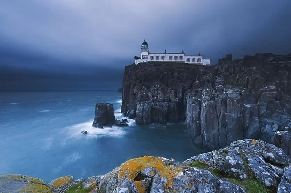 Rocky cliff on the sea, with a lighthouse on the reef, Neist Point, Isle of Skye