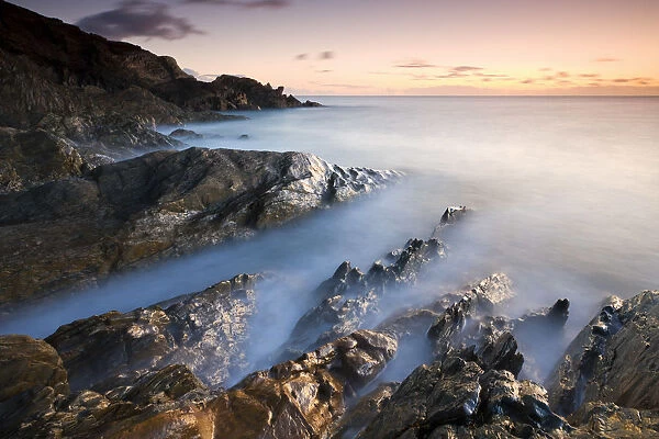 Rocky coast at Sunset, Leas Foot Sand, Thurlestone, South Hams, Devon, England. Winter