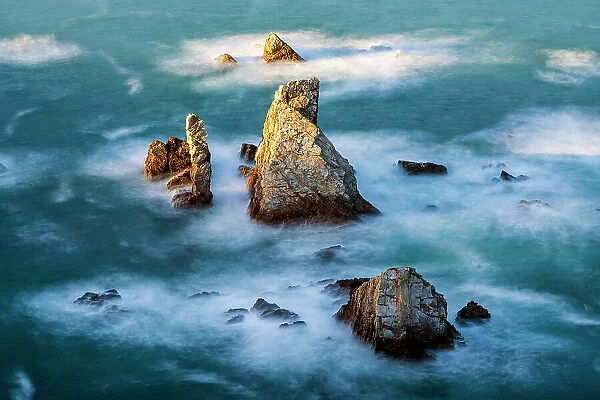 Rocky islets at Playa Gueirua, Cudillero, Asturias, Spain