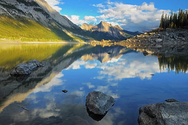 Rocky Mountains and Colin Ridge reflected in Medicine Lake at sunset, Jasper National Park, Alberta, Canada