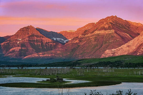 Rocky Mountains at sunrise and Maskinonge Lake. Waterton Lakes National Park, Alberta, Canada
