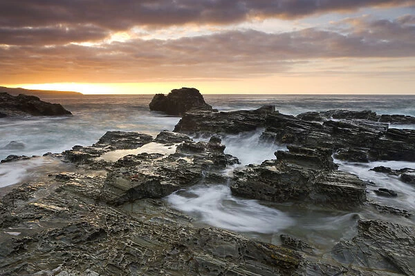 Rocky shores of Godrevy Point at sunset, Cornwall, England. Autumn (October) 2009