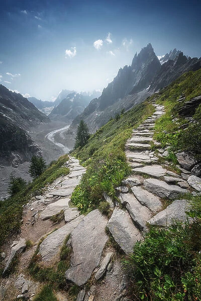 A rocky trail goes up in the mountains from the famous Mer de Glace above Chamonix. French Alps