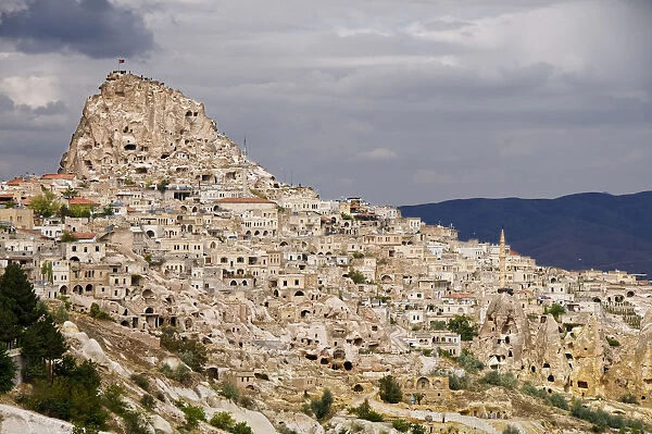 The rocky village of Uchisar, above the old Silk Road plains of Cappadocia. Turkey, Asia