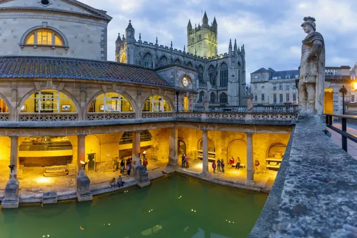 Framed Print : The Roman Baths and Bath Cathedral illuminated at dusk, Bath, Somerset, England