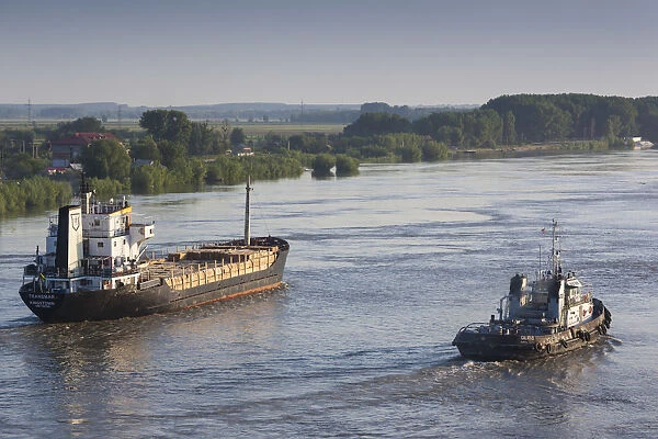 Romania, Danube River Delta, Tulcea, elevated view of freighter on the Danube River, dawn