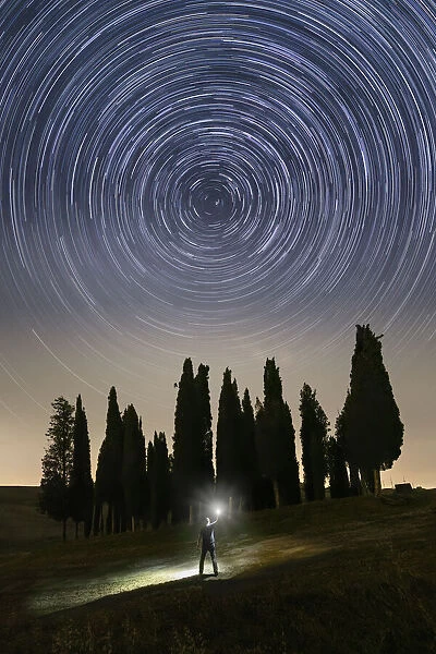 The rotation of the stars around Polaris, near the iconic Cypresses of San Quirico d