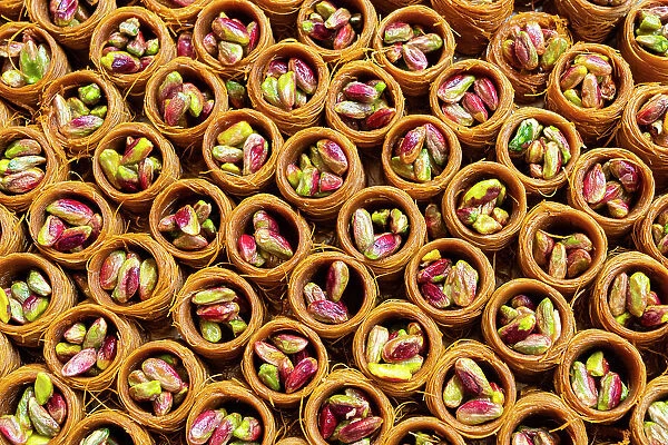 Detail of round traditional Turkish dessert baklava with pistachio nuts, Egyptian Bazaar (Spice Bazaar), Eminonu, Fatih District, Istanbul Province, Turkey