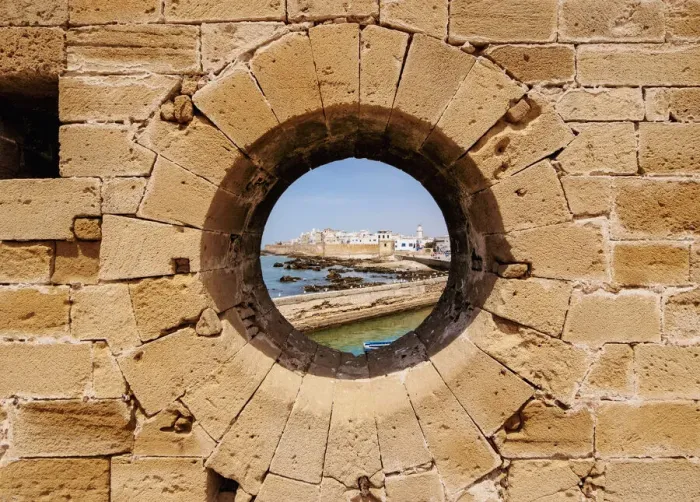 Framed Print : Round window in the walls of the Citadel by the Scala Harbour, Essaouira