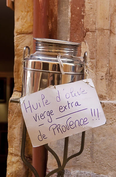 Rousillion; France. A hand made sign on a can of virgin olive oil for sale in Provence