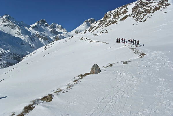 row of snowshoeing is directed towards the summit Cufercalhutte, Switzerland