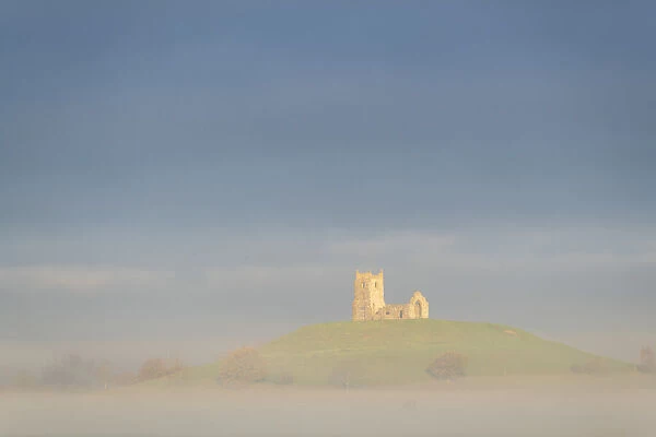 The ruins of St Michaels Church on a misty morning on the Somerset Levels, Burrow Mump, Burrowbridge, Somerset. Englnad, Autumn (November) 2021