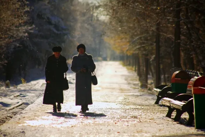 Framed Print : Russia, Far East, Sakhalin; Yuzhno-Sakhalinsk; Two elderly woman walking amidst trees in the main park of