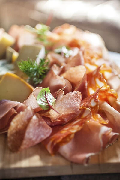 Rustic platter with sausage, ham and cheese on an alpine hut in South Tyrol, Italy, South Tyrol, Italy