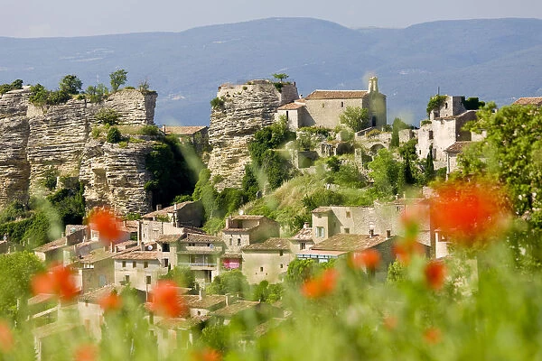Saignon, Luberon, Provence, France. Poppies & view of village