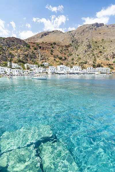 Sail boat in the turquoise crystal sea surrounding Loutro village, Crete island, Greece