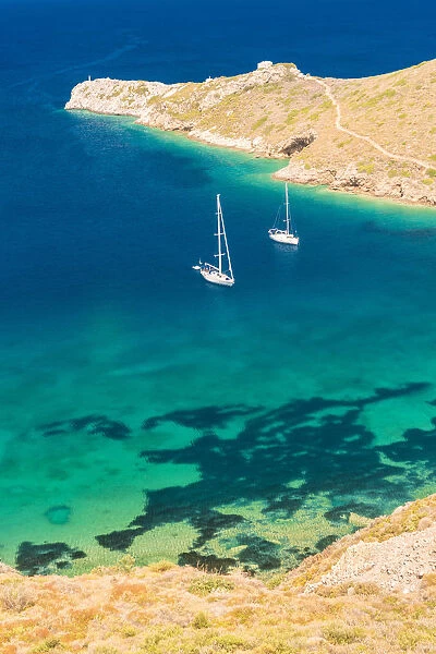 Sailing boats floating on the turquoise aegean sea at Porto Kagio, Laconia region